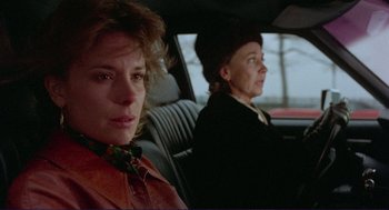 Movie still from “Sisters” (1972), directed by Brian De Palma – Two women sitting in the back seat of a car; Close Up shot, Over the shoulder angle