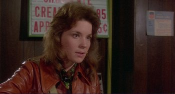 Movie still from “Sisters” (1972), directed by Brian De Palma – A woman in a leather jacket is looking at the camera; Close Up shot, Over the shoulder angle