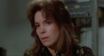 Movie still from “Sisters” (1972), directed by Brian De Palma – A person with long brown hair; Close Up shot, Over the shoulder angle