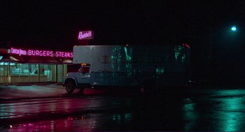 Movie still from “Sisters” (1972), directed by Brian De Palma – A truck driving down a street at night; Extreme Wide shot, Low angle