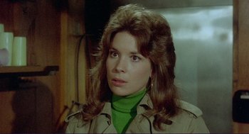 Movie still from “Sisters” (1972), directed by Brian De Palma – A person wearing a green shirt; Close Up shot, High angle