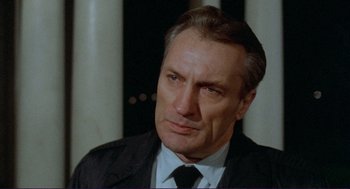 Movie still from “Sisters” (1972), directed by Brian De Palma – A man in a suit and a tie; Close Up shot, Low angle