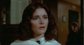 Movie still from “Sisters” (1972), directed by Brian De Palma – A person wearing a white shirt and tie; Close Up shot, Over the shoulder angle