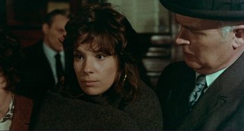 Movie still from “Sisters” (1972), directed by Brian De Palma – A woman sitting in front of another woman; Close Up shot, Over the shoulder angle