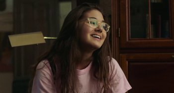 Movie still from “Skate Kitchen” (2018), directed by Crystal Moselle – A girl with glasses is sitting in front of a window; Close Up shot, Over the shoulder angle