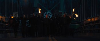 Movie still from “Skin” (2018), directed by Guy Nattiv – A group of people holding up signs in the dark at night; Wide shot, High angle