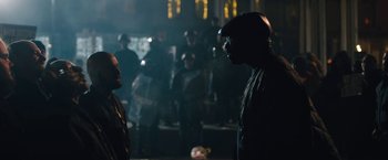 Movie still from “Skin” (2018), directed by Guy Nattiv – Two men are standing in a dark room; Medium shot, Over the shoulder angle