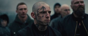 Movie still from “Skin” (2018), directed by Guy Nattiv – A man that has a tattoo on his head; Close Up shot, Over the shoulder angle