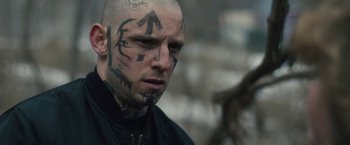Movie still from “Skin” (2018), directed by Guy Nattiv – A bald man with tattoos on his face; Close Up shot, Over the shoulder angle