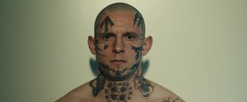 Movie still from “Skin” (2018), directed by Guy Nattiv – A man with tattoos on his face and neck; Close Up shot, Low angle