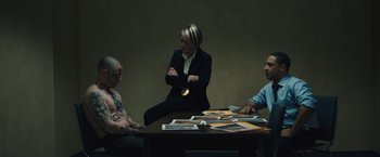 Movie still from “Skin” (2018), directed by Guy Nattiv – Three people sitting at a table in a room; Medium shot, Over the shoulder angle