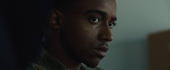 Movie still from “Skin” (2018), directed by Guy Nattiv – A man's face in a dark room; Close Up shot, Over the shoulder angle