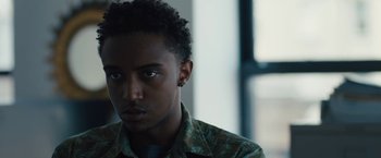 Movie still from “Skin” (2018), directed by Guy Nattiv – A person wearing a camouflage shirt; Close Up shot, Over the shoulder angle