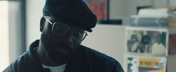 Movie still from “Skin” (2018), directed by Guy Nattiv – A person wearing glasses and a hat; Close Up shot, Low angle
