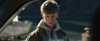Movie still from “Skin” (2018), directed by Guy Nattiv – A young man holding a bottle of beer in his hand; Close Up shot, Over the shoulder angle