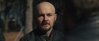 Movie still from “Skin” (2018), directed by Guy Nattiv – A bald man with a beard and a mustache; Close Up shot, Over the shoulder angle