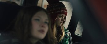 Movie still from “Skin” (2018), directed by Guy Nattiv – Two young girls in a car looking out the window; Close Up shot, Over the shoulder angle