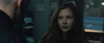 Movie still from “Skin” (2018), directed by Guy Nattiv – A woman with long brown hair and blue eyes looking into the distance; Close Up shot, Over the shoulder angle