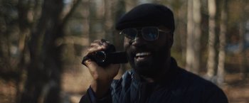 Movie still from “Skin” (2018), directed by Guy Nattiv – A man holding a video camera in his hand; Close Up shot, Over the shoulder angle