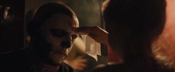 Movie still from “Skin” (2018), directed by Guy Nattiv – A person is putting makeup on another person's face; Close Up shot, Over the shoulder angle