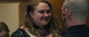 Movie still from “Skin” (2018), directed by Guy Nattiv – A person with long hair wearing a necklace; Close Up shot, Over the shoulder angle