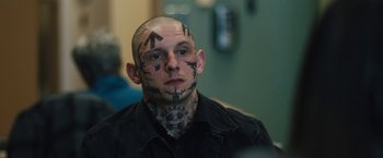 Movie still from “Skin” (2018), directed by Guy Nattiv – A man with tattoos on his head and face; Close Up shot, Over the shoulder angle