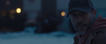Movie still from “Skin” (2018), directed by Guy Nattiv – A man wearing a baseball cap is looking into the distance; Close Up shot, Low angle