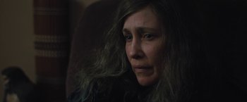 Movie still from “Skin” (2018), directed by Guy Nattiv – A person sitting on a couch; Close Up shot, High angle