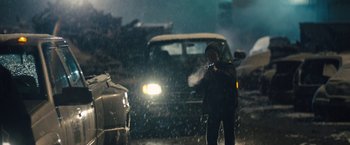 Movie still from “Skin” (2018), directed by Guy Nattiv – A man standing in the middle of the street in the rain; Wide shot, Low angle