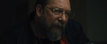 Movie still from “Skin” (2018), directed by Guy Nattiv – A person with a beard wearing glasses; Close Up shot, Over the shoulder angle