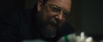 Movie still from “Skin” (2018), directed by Guy Nattiv – A man with a beard and glasses looking at a cell phone; Close Up shot, Over the shoulder angle