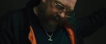 Movie still from “Skin” (2018), directed by Guy Nattiv – A person with a beard wearing glasses; Close Up shot, Low angle