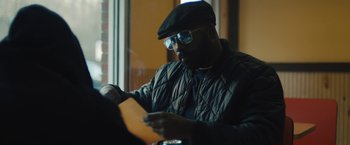 Movie still from “Skin” (2018), directed by Guy Nattiv – A man sitting in front of a window looking at a piece of paper; Close Up shot, Over the shoulder angle