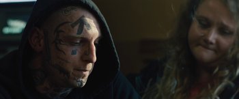 Movie still from “Skin” (2018), directed by Guy Nattiv – A man with a hooded jacket and a hooded sweatshirt; Close Up shot, Over the shoulder angle
