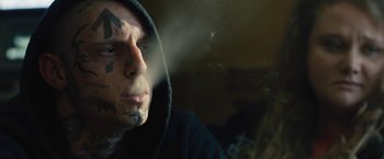Movie still from “Skin” (2018), directed by Guy Nattiv – A man with a face covered in tattoos; Close Up shot, Over the shoulder angle