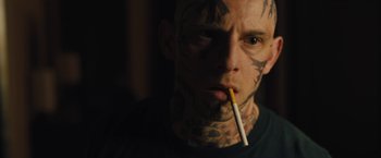 Movie still from “Skin” (2018), directed by Guy Nattiv – A man with a cigarette in his mouth; Close Up shot, Over the shoulder angle