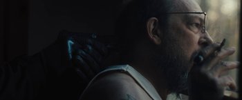 Movie still from “Skin” (2018), directed by Guy Nattiv – A man with a beard is holding something in his hand; Close Up shot, Over the shoulder angle