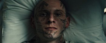 Movie still from “Skin” (2018), directed by Guy Nattiv – A man with tattoos on his head and face; Close Up shot, Overhead angle