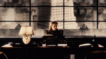 Movie still from “Sky Captain and the World of Tomorrow” (2004), directed by Kerry Conran – A woman sitting at a desk in front of a window; Wide shot, High angle