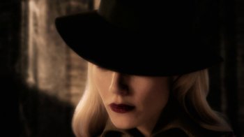 Movie still from “Sky Captain and the World of Tomorrow” (2004), directed by Kerry Conran – A person wearing a black hat; Extreme Close Up shot, Over the shoulder angle