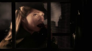 Movie still from “Sky Captain and the World of Tomorrow” (2004), directed by Kerry Conran – A woman talking on a phone in front of a window; Close Up shot, Low angle