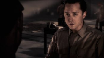 Movie still from “Sky Captain and the World of Tomorrow” (2004), directed by Kerry Conran – A man in a brown shirt is looking at the camera; Close Up shot, Over the shoulder angle