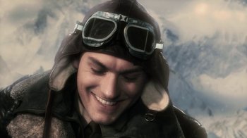 Movie still from “Sky Captain and the World of Tomorrow” (2004), directed by Kerry Conran – A man wearing a pilot's hat and goggles smiling; Close Up shot, High angle