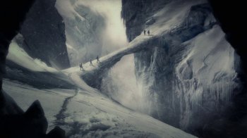 Movie still from “Sky Captain and the World of Tomorrow” (2004), directed by Kerry Conran – A group of skiers are walking on a snowy mountain; Extreme Wide shot, High angle