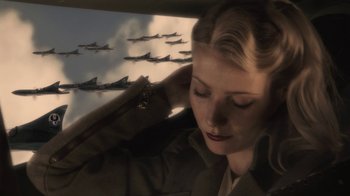 Movie still from “Sky Captain and the World of Tomorrow” (2004), directed by Kerry Conran – A woman in a military uniform with a bunch of fighter jets in the background; Close Up shot, Low angle