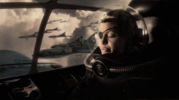Movie still from “Sky Captain and the World of Tomorrow” (2004), directed by Kerry Conran – A woman wearing a helmet is in the cockpit of an airplane; Medium shot, Low angle