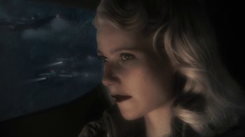 Movie still from “Sky Captain and the World of Tomorrow” (2004), directed by Kerry Conran – A woman with blonde hair looking out a window; Close Up shot, High angle