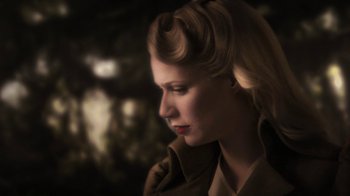 Movie still from “Sky Captain and the World of Tomorrow” (2004), directed by Kerry Conran – A woman in a trench coat looking to the side; Close Up shot, Low angle