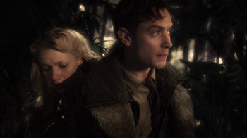 Movie still from “Sky Captain and the World of Tomorrow” (2004), directed by Kerry Conran – A man and a woman are standing in the woods; Close Up shot, Low angle