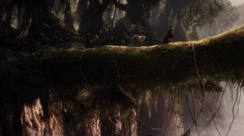 Movie still from “Sky Captain and the World of Tomorrow” (2004), directed by Kerry Conran – A bear sitting on top of a tree in the middle of a forest; Extreme Wide shot, High angle